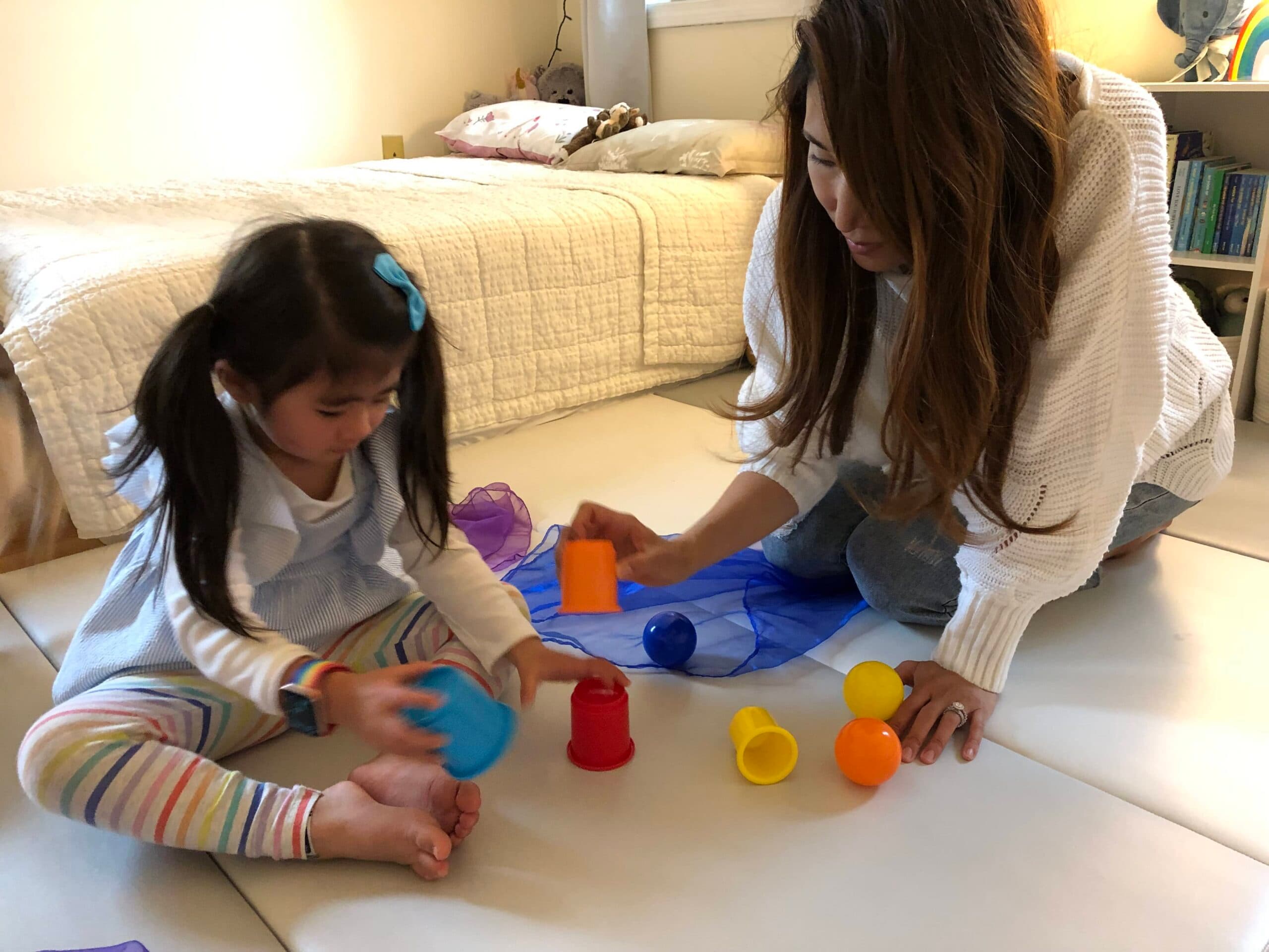 kid and parent playing with toys