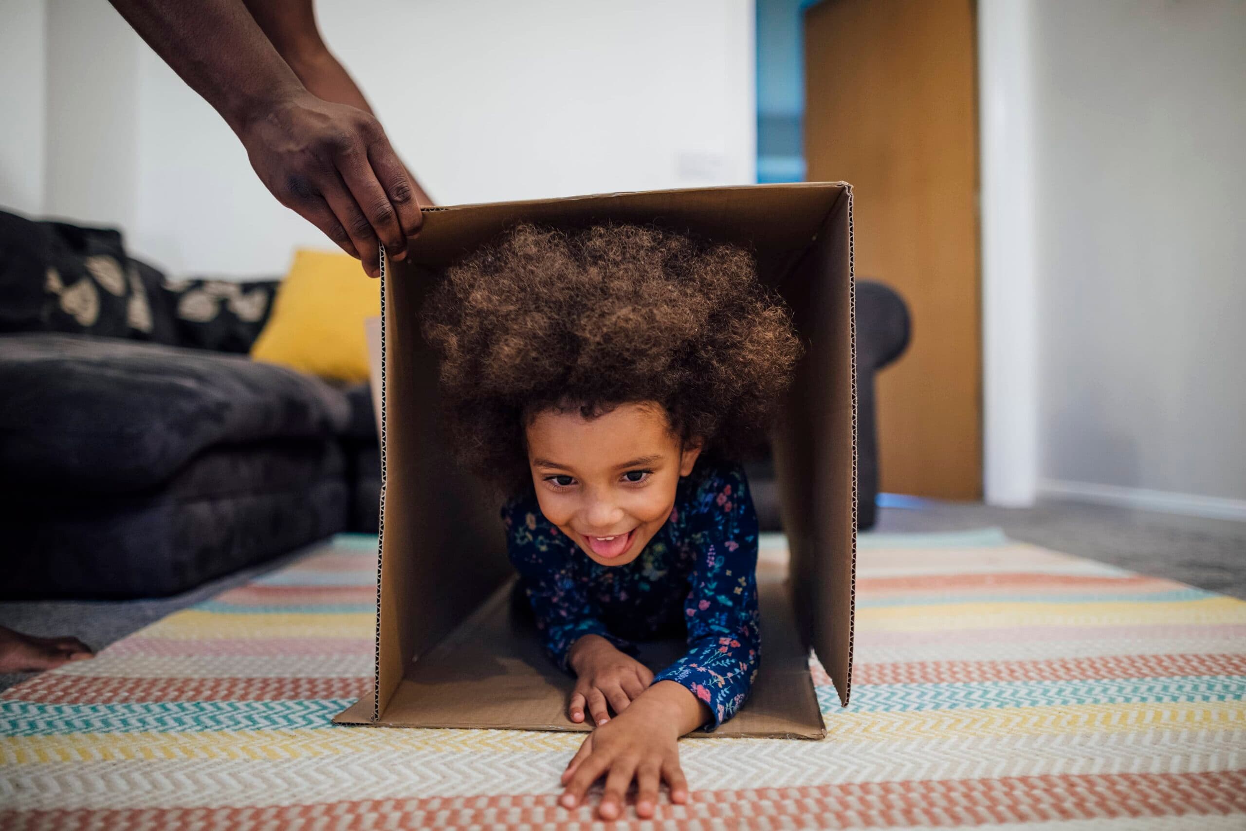 child crawling through a box